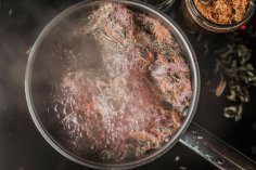 Boiling medieval cooking wine with wild herbs