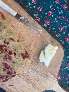 Wild strawberry bread with butter on a cutting board